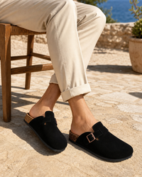 Man wearing black backless with linen trousers