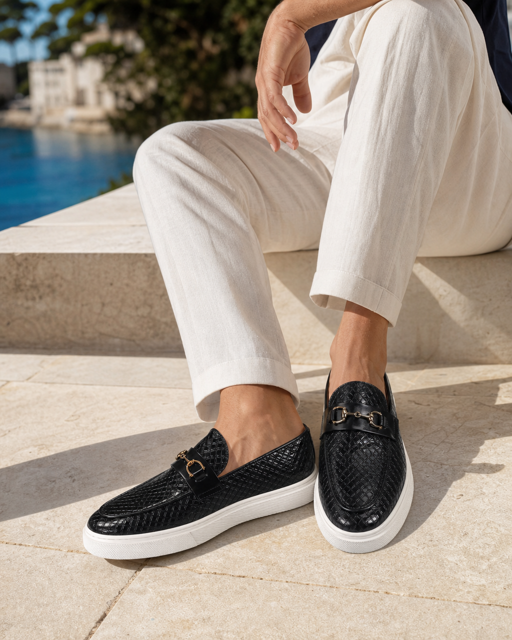 Man wearing black bit with linen trousers