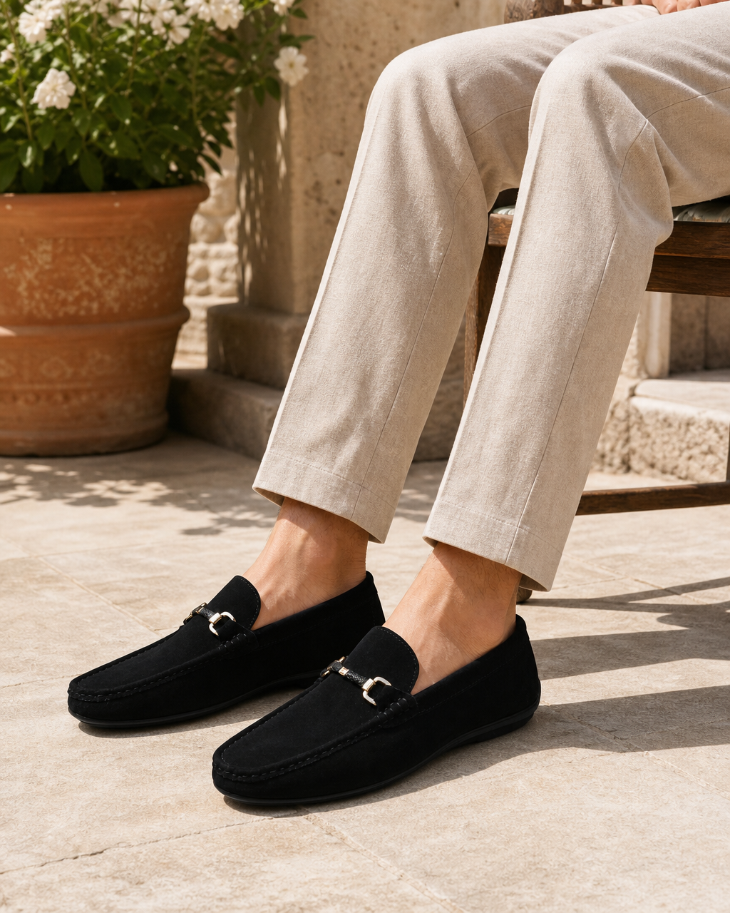 Man wearing black bit with linen trousers