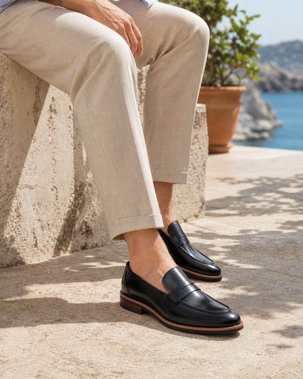 Man wearing black bit with linen trousers