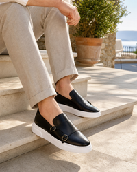 Man wearing black monk with linen trousers