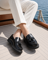 Man wearing black penny with linen trousers