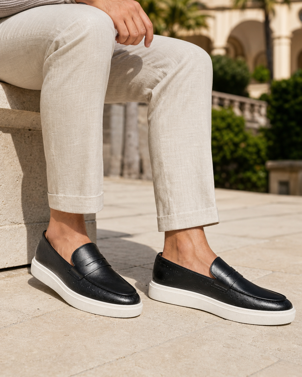 Man wearing black penny with linen trousers