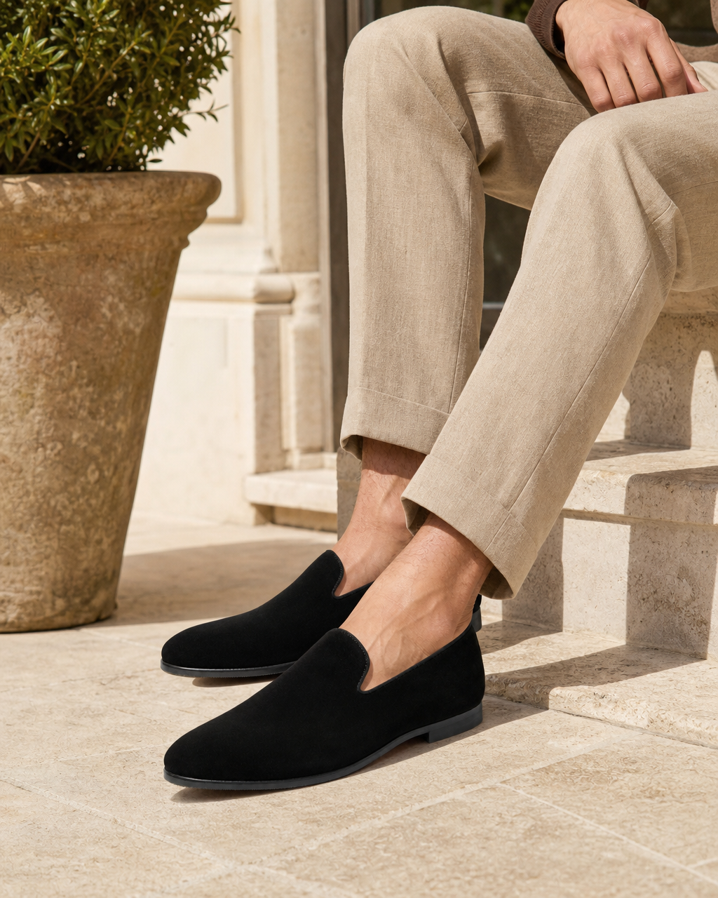 Man wearing black slip on with linen trousers