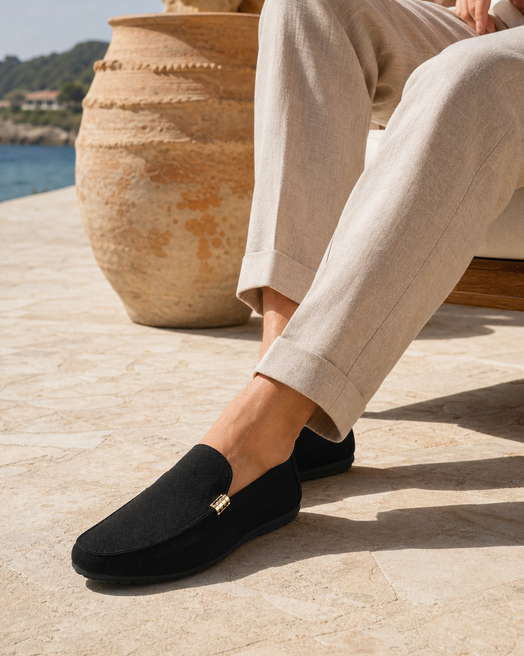 Man wearing black slip on with linen trousers