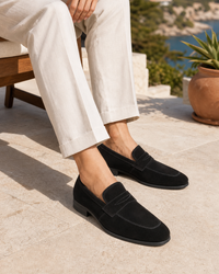 Man wearing black slip on with linen trousers