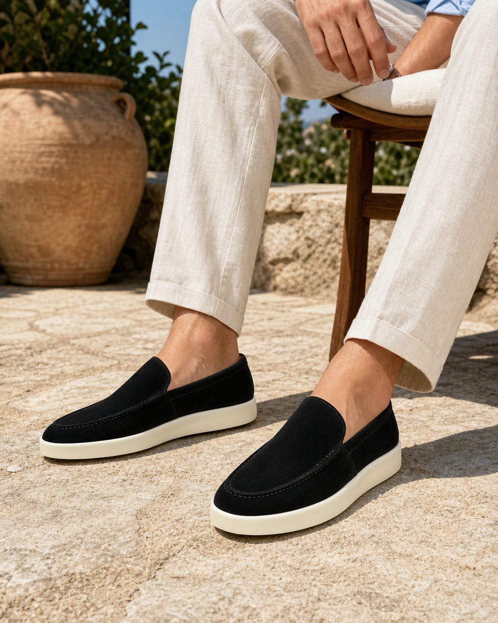 Man wearing black slip on with linen trousers