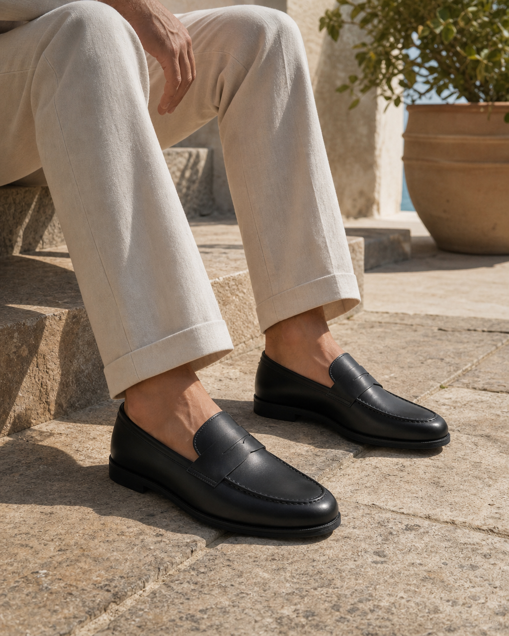 Man wearing black slip on with linen trousers