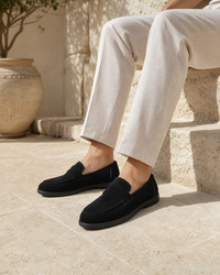 Man wearing black slip on with linen trousers