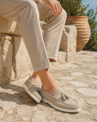 Man wearing cream tassel with linen trousers