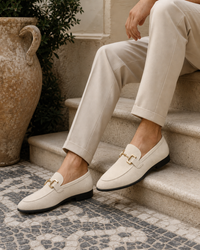 Man wearing ivory bit with linen trousers