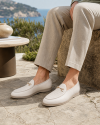 Man wearing ivory bit with linen trousers