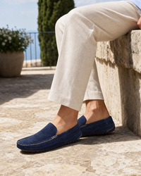 Man wearing navy slip on with linen trousers