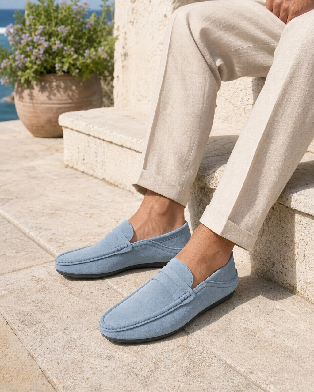 Man wearing pale blue driving with linen trousers